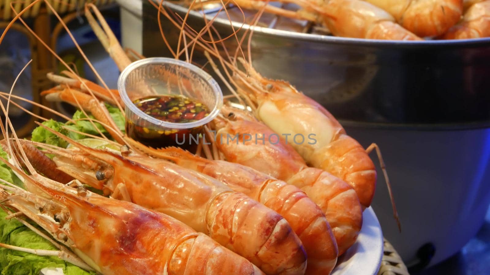 National Asian Exotic ready to eat seafood at night street market food court in Thailand. Delicious Grilled Prawns or Shrimps and other snacks