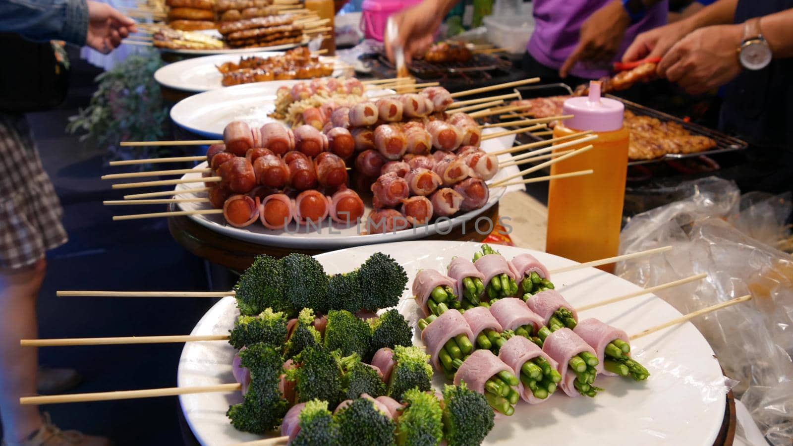 Traditional Asian night street food market in Thailand. Barbecue meatballs and other exotic delicious snacks for sail. Ready to eat food.