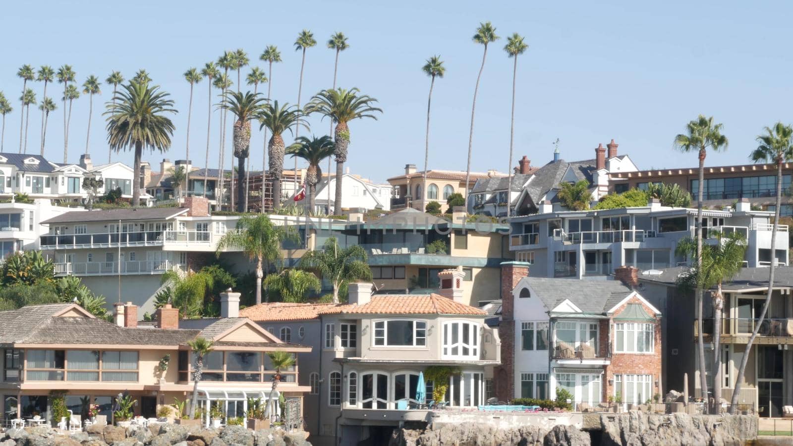 Luxury property, beachfront real estate on pacific ocean coast, Newport beach harbor, California, USA. Weekend premium seafront rental homes near Los Angeles. Vacation rich suburban waterfront houses by DogoraSun