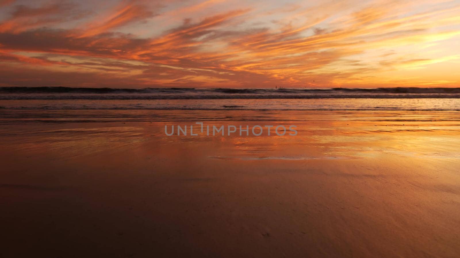 California summertime beach aesthetic, golden sunset. Vivid dramatic clouds over pacific ocean waves. Santa Monica popular resort, Los Angeles CA USA. Atmospheric moody purple evening sundown in LA.