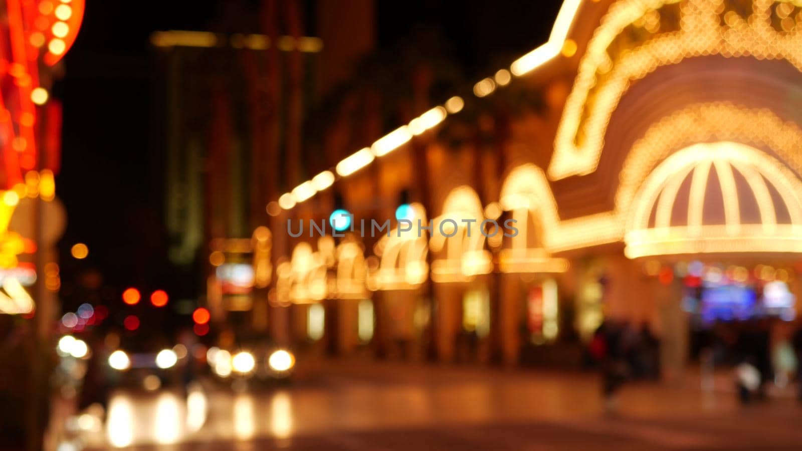 Defocused fabulous Las Vegas Strip boulevard, luxury casino and hotel, gambling area in Nevada, USA. Nightlife and traffic near Fremont street in tourist money playing resort. Neon lights of sin city.