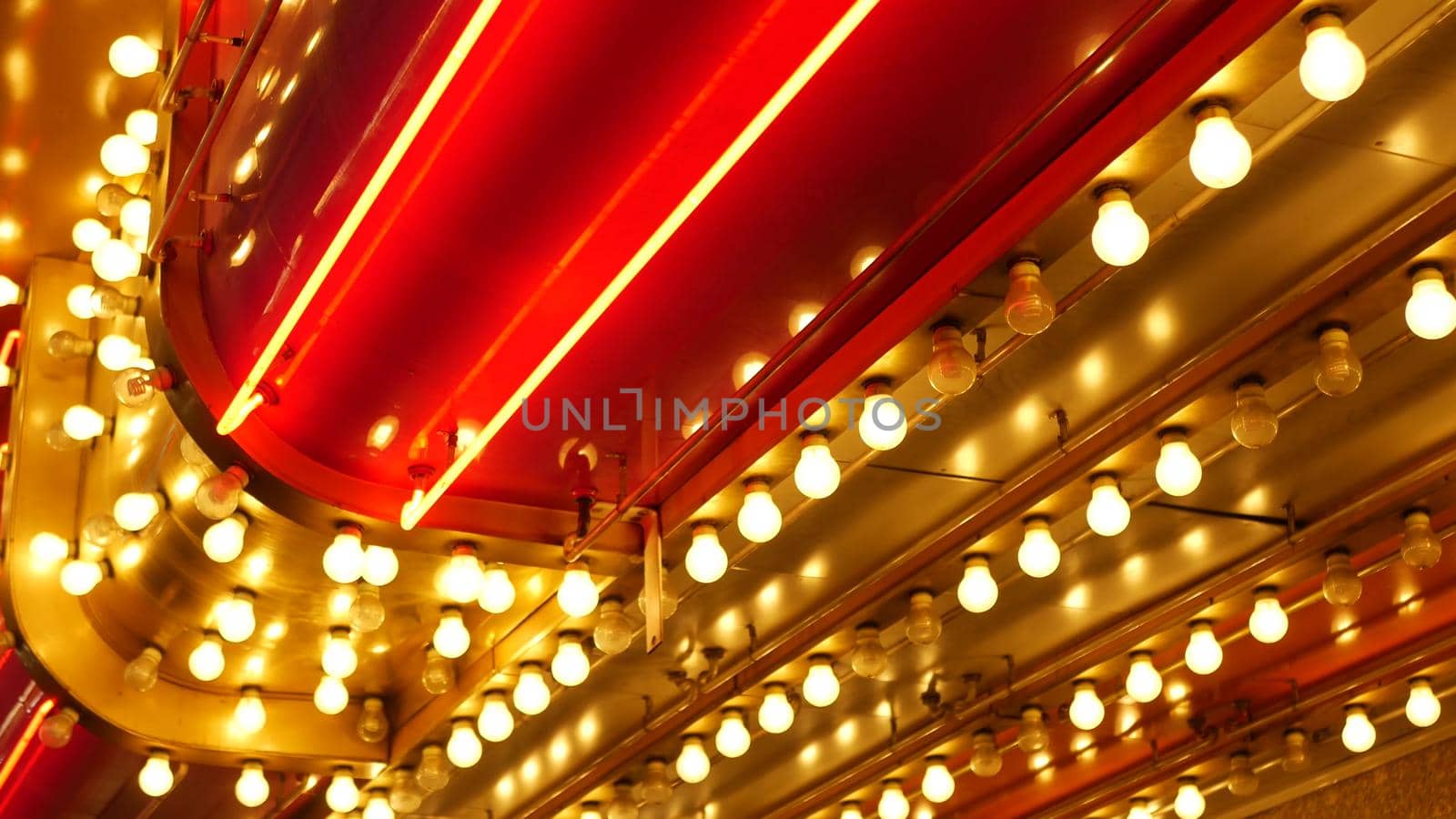 Old fasioned electric lamps blinking and glowing at night. Abstract close up of retro casino decoration shimmering in Las Vegas, USA. Illuminated vintage style bulbs glittering on Freemont street.