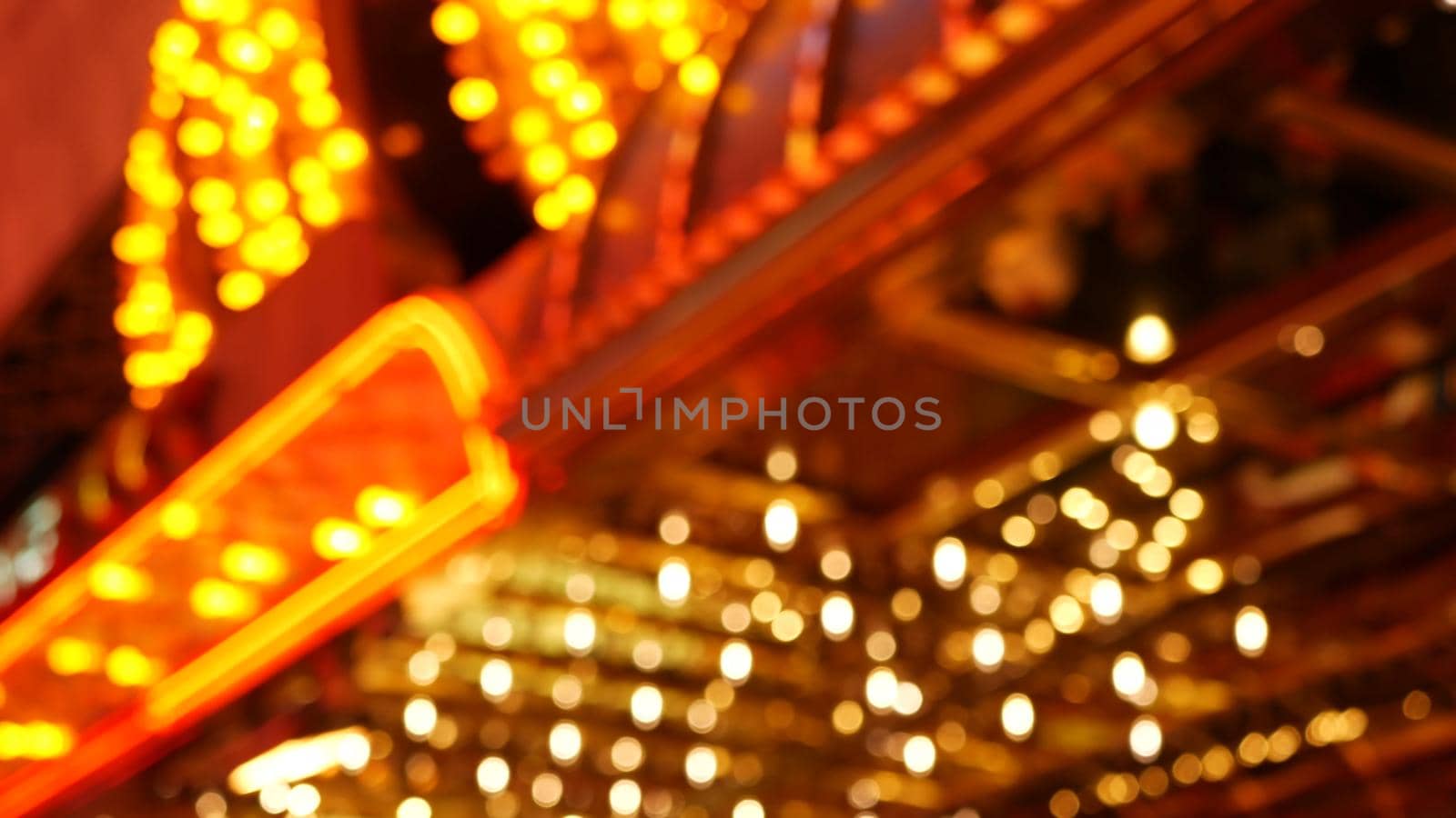 Defocused old fasioned electric lamps glowing at night. Abstract close up of blurred retro casino decoration shimmering, Las Vegas USA. Illuminated vintage style bulbs glittering on Freemont street.