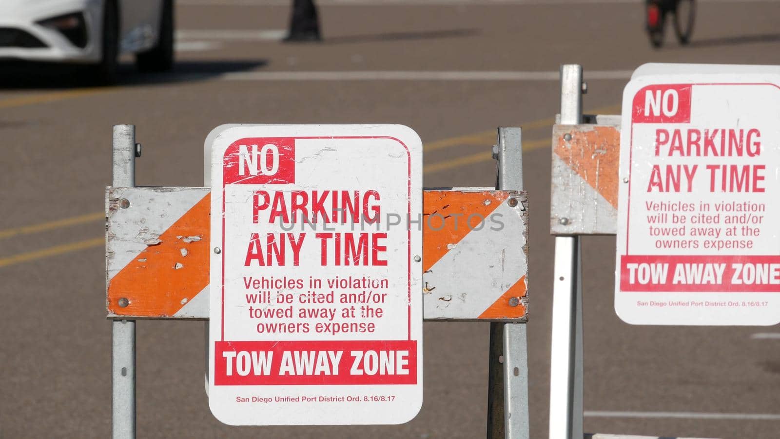 Parking lot sign as symbol of traffic difficulties and transportation issues in busy urban areas of USA. Public paid parking zone in downtown of San Diego, California. Limited space for cars in city by DogoraSun