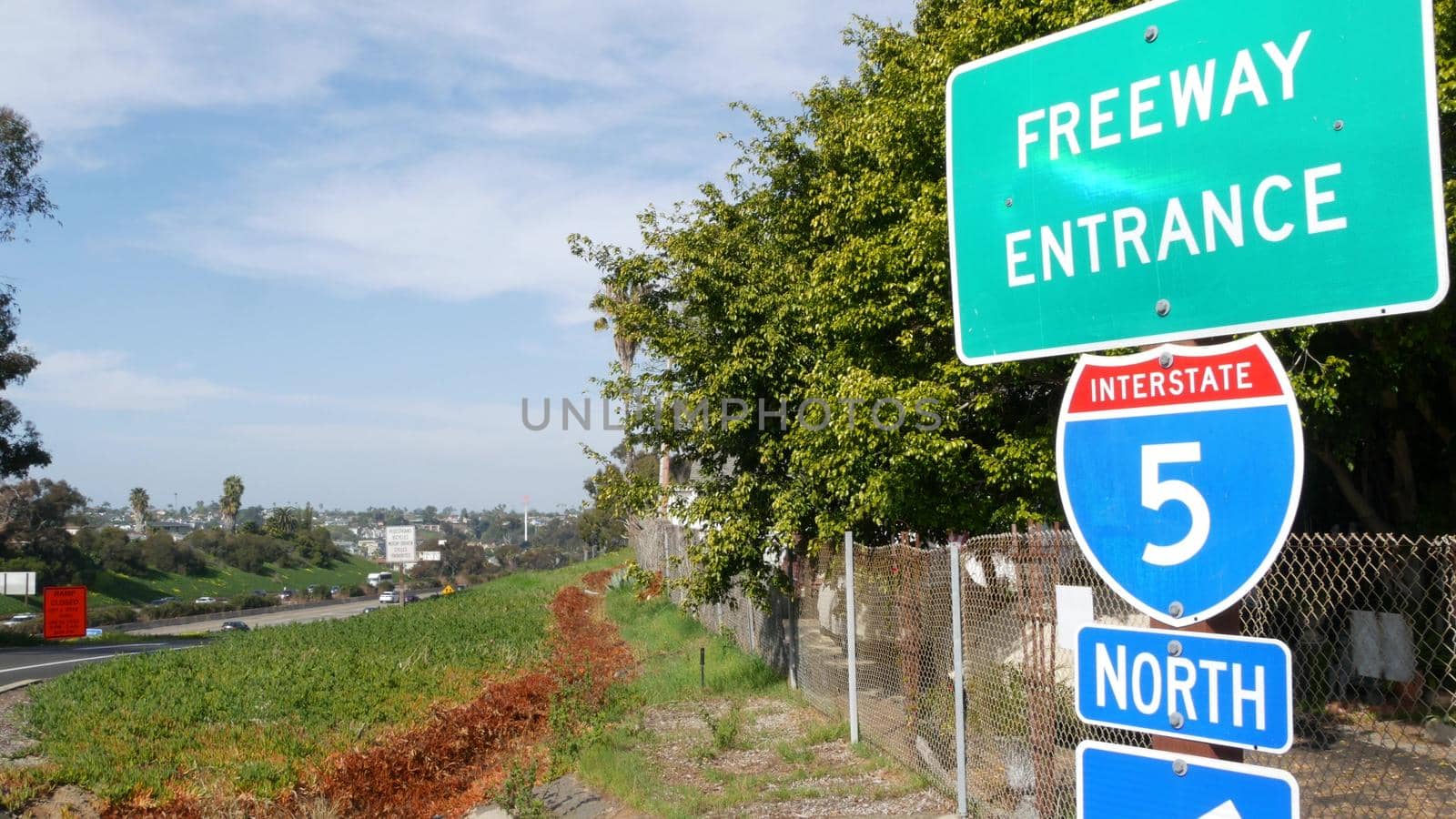 Freeway entrance, information sign on crossraod in USA. Route to Los Angeles, California. Interstate highway 5 signpost as symbol of road trip, transportation and traffic safety rules and regulations.