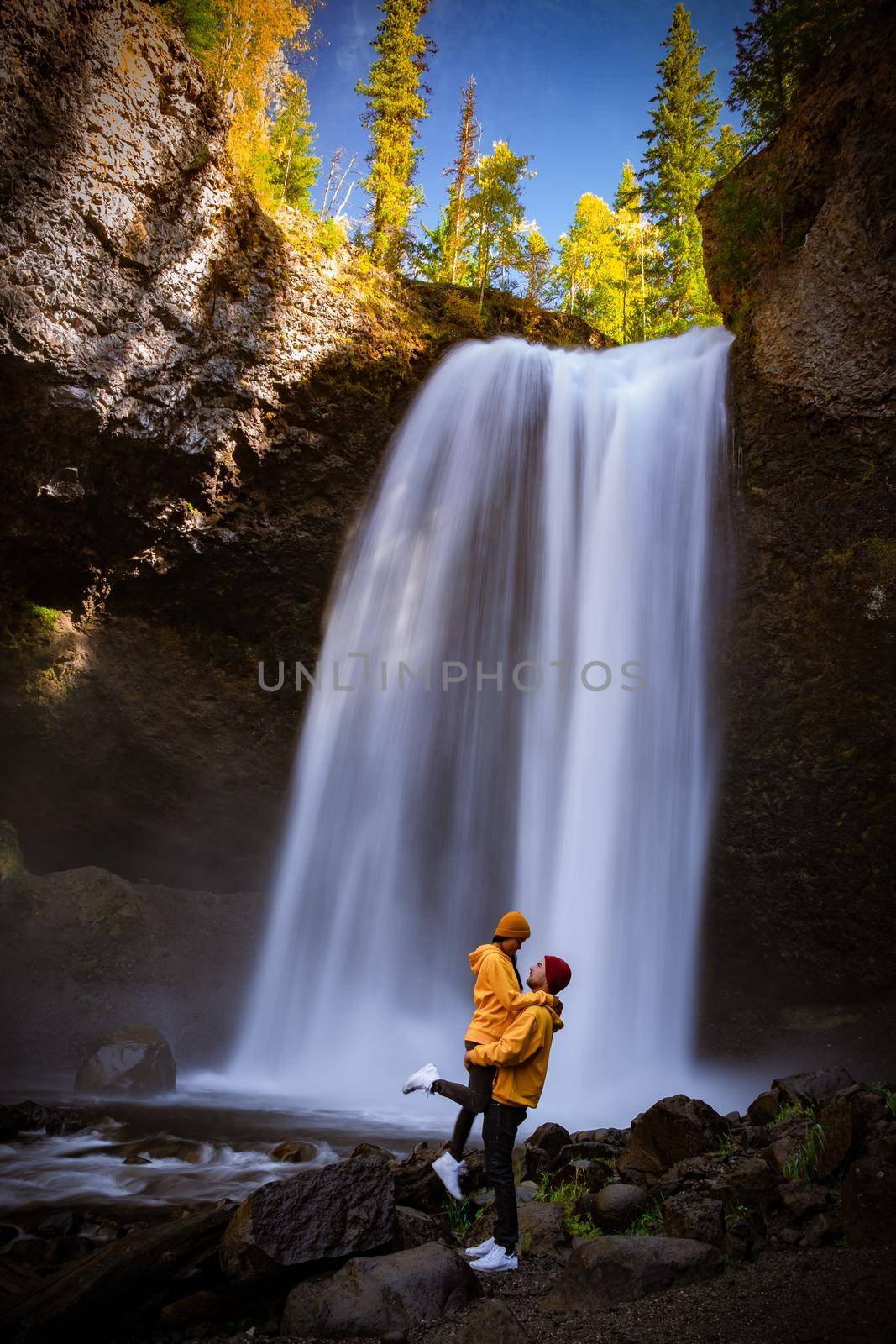 Wells Gray British Colombia Canada, couple on vacation visit spectacular water flow hikingof Helmcken Falls on the Murtle River in Wells Gray Provincial Park Clearwater, British Columbia, 