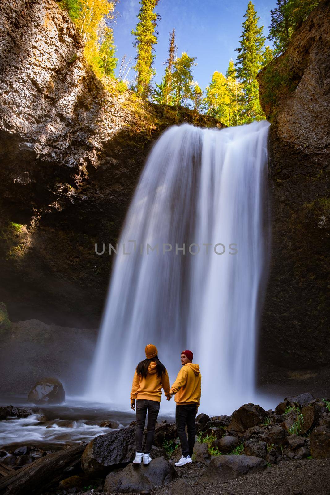 Wells Gray British Colombia Canada, couple on vacation visit spectacular water flow hikingof Helmcken Falls on the Murtle River in Wells Gray Provincial Park Clearwater, British Columbia, 