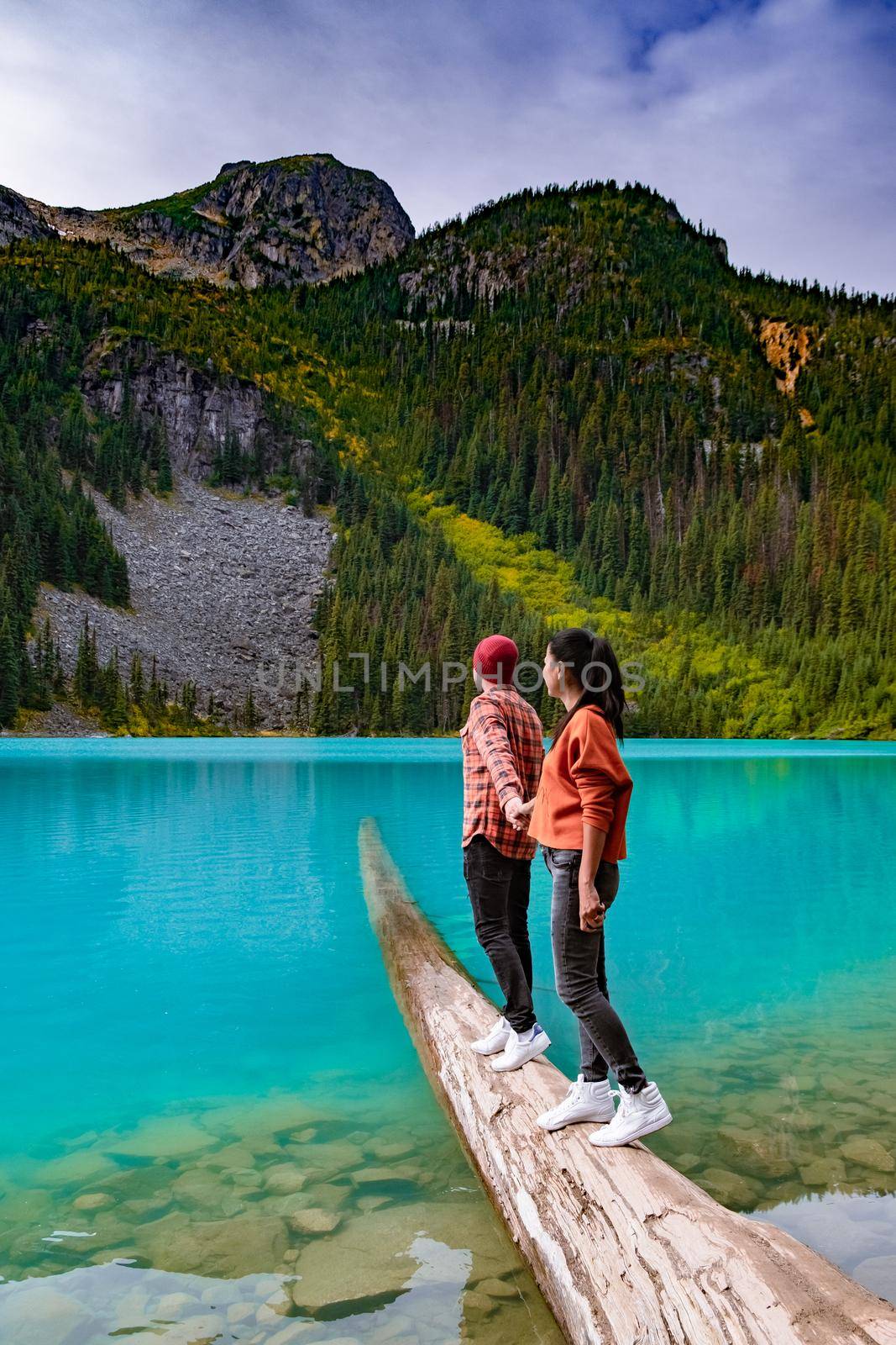 Majestic mountain lake in Canada. Upper Joffre Lake Trail View, couple visit Joffre Lakes Provincial Park - Middle Lake. British Colmbia Canada