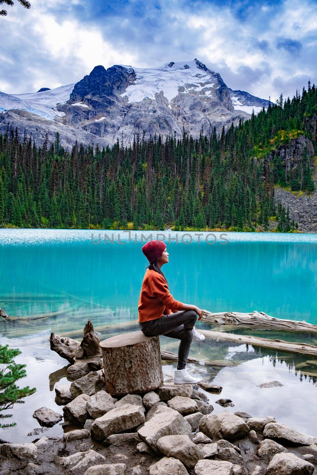 Majestic mountain lake in Canada. Upper Joffre Lake Trail View, woman visit Joffre Lakes Provincial Park - Middle Lake. British Colmbia Canada