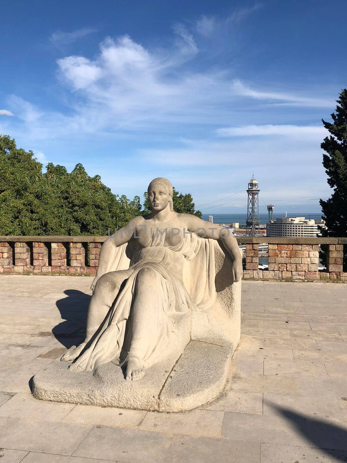 Statue at the mountain Montjuïc  by traveltelly