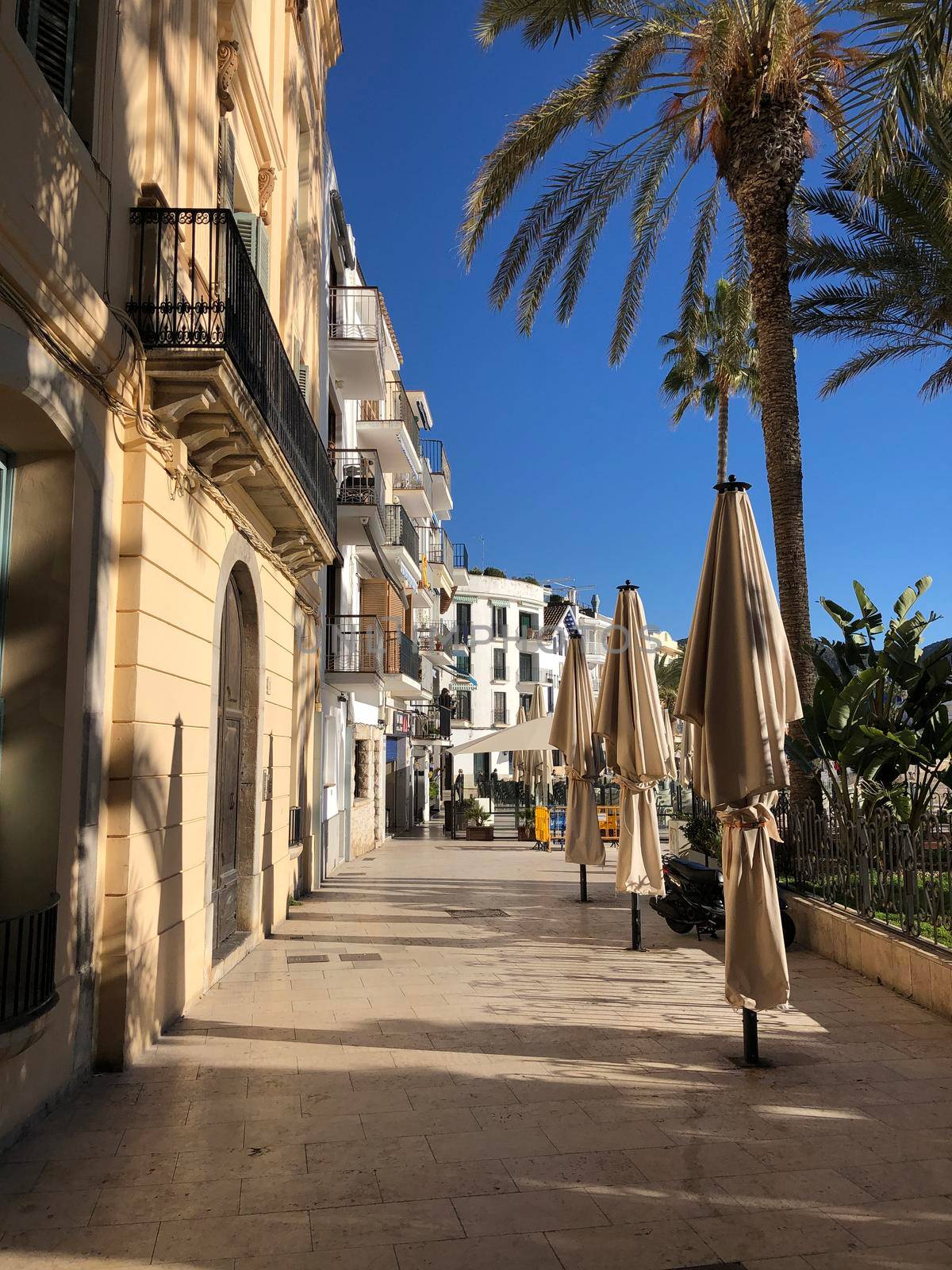 Empty terrace in Sitges by traveltelly