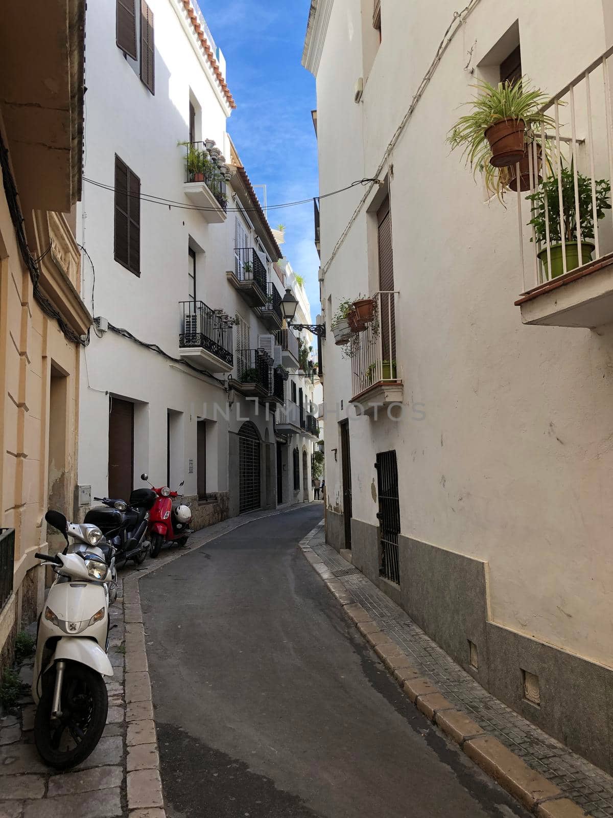 Street in the old town of Sitges by traveltelly