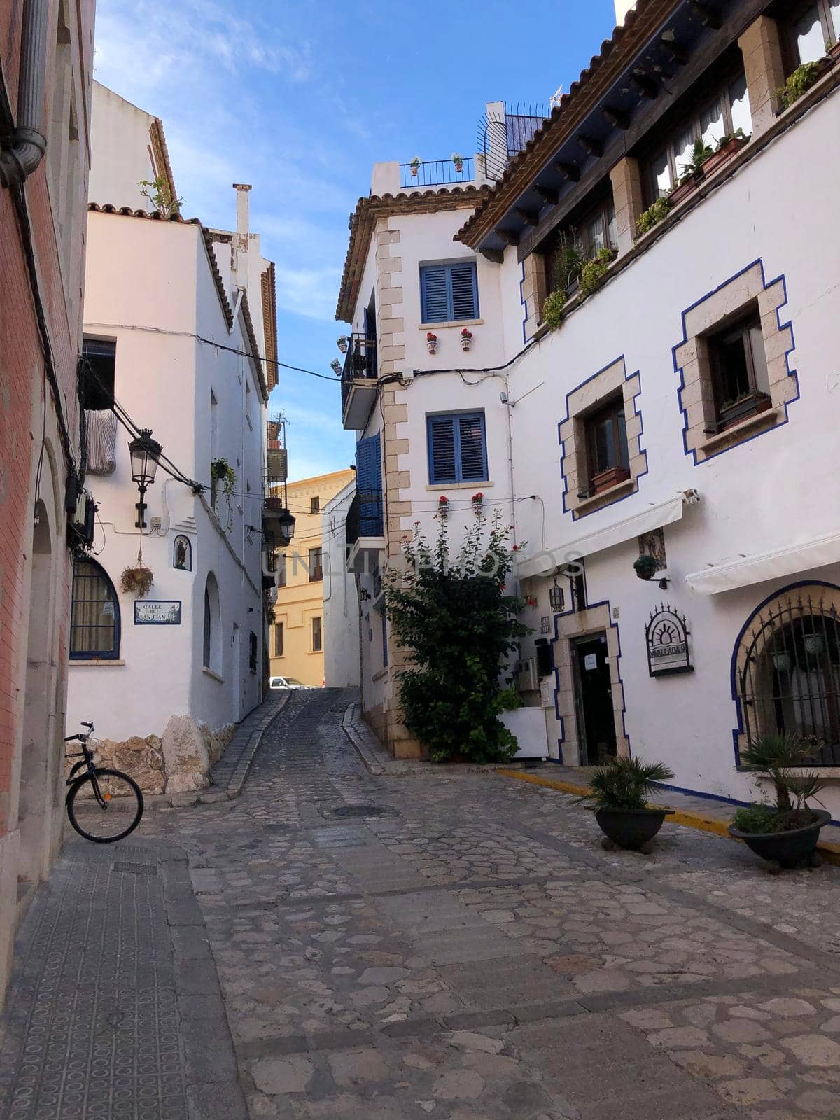 Street in the old town of Sitges by traveltelly