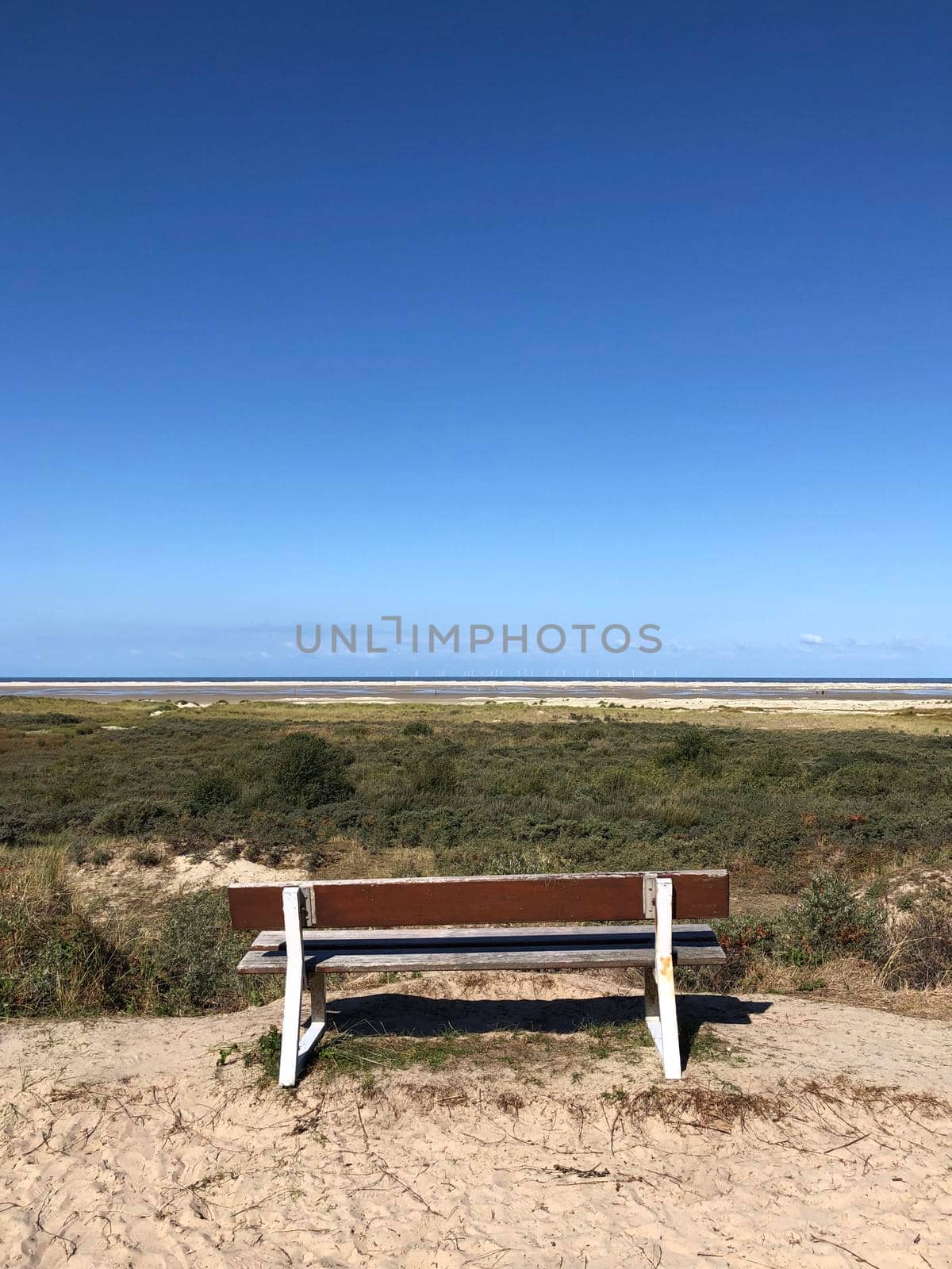 Bench near the beach on Borkum island by traveltelly