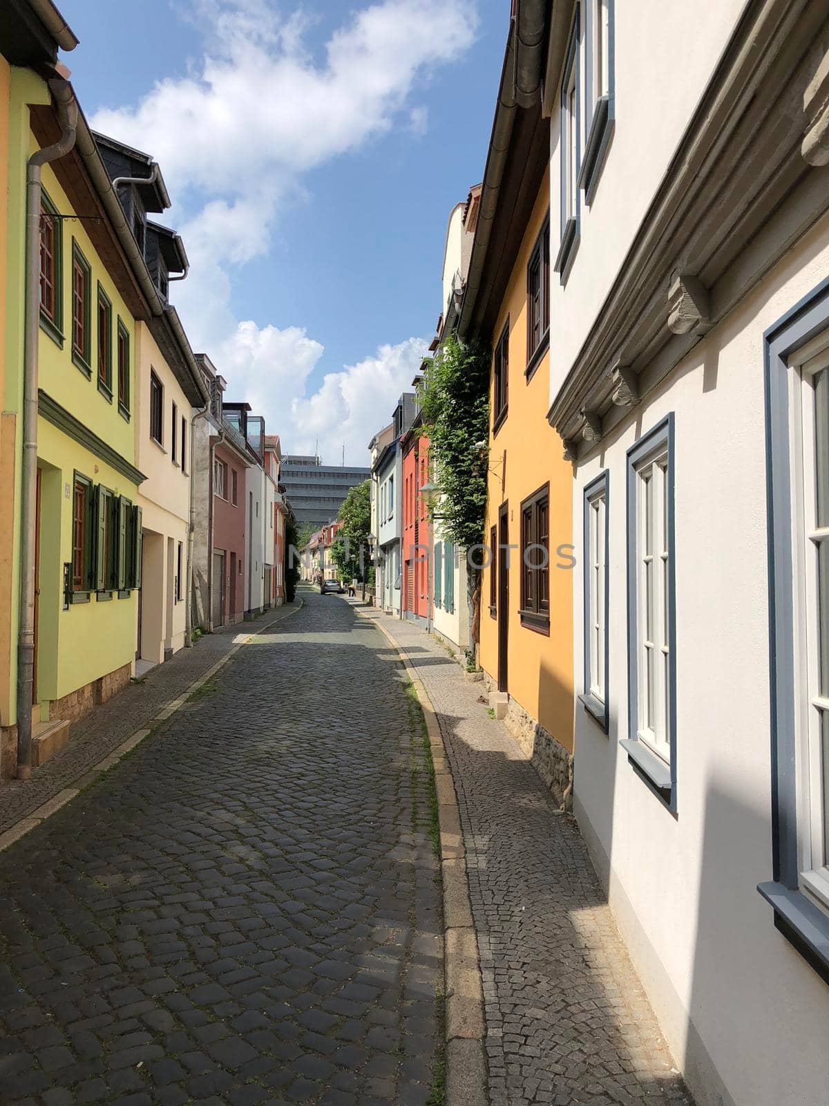 Street with colorful houses in Erfurt  by traveltelly