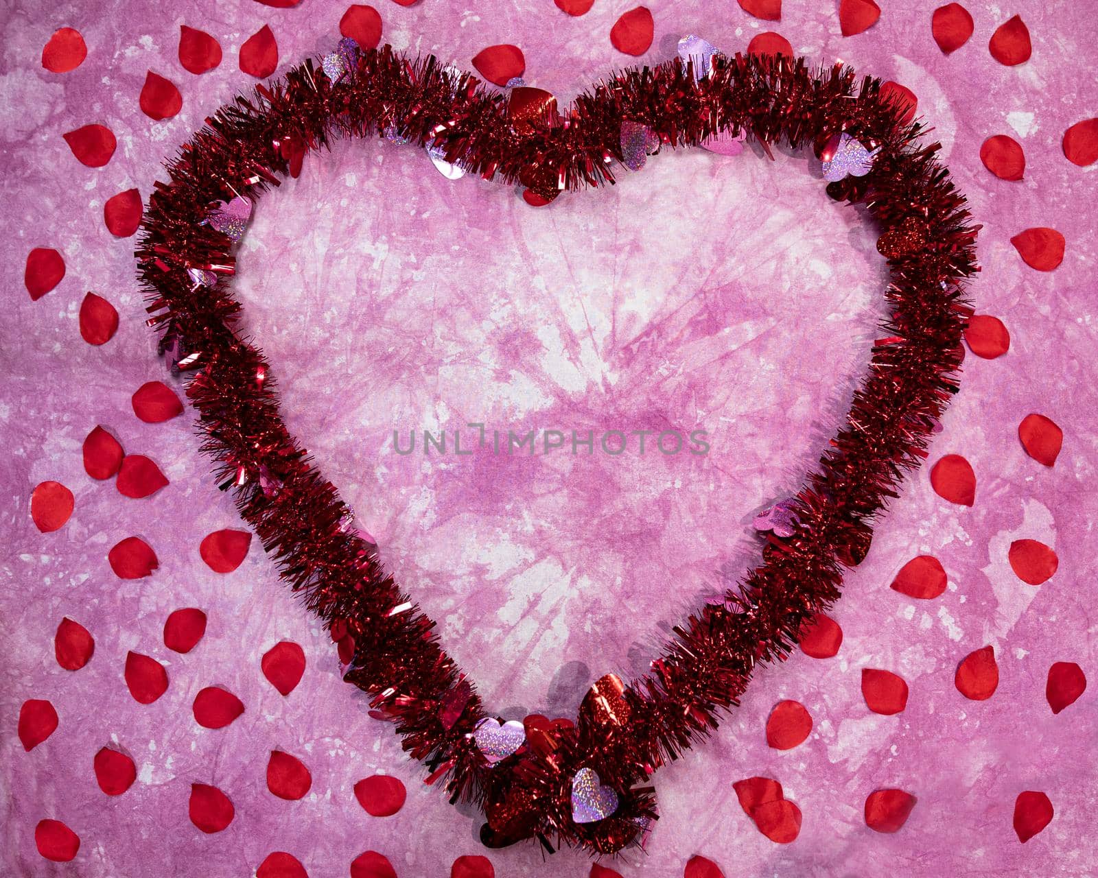 Garland Valentine's heart flat lay frame with rose petals.