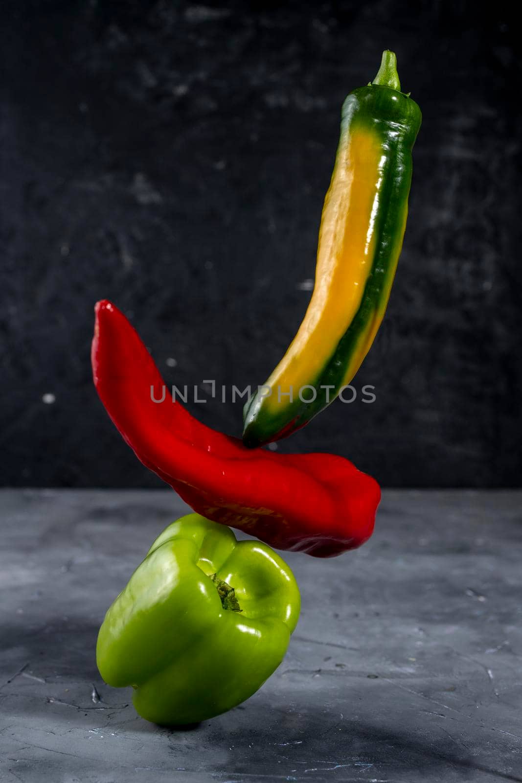 Colorful fresh peppers on gray background template by sashokddt