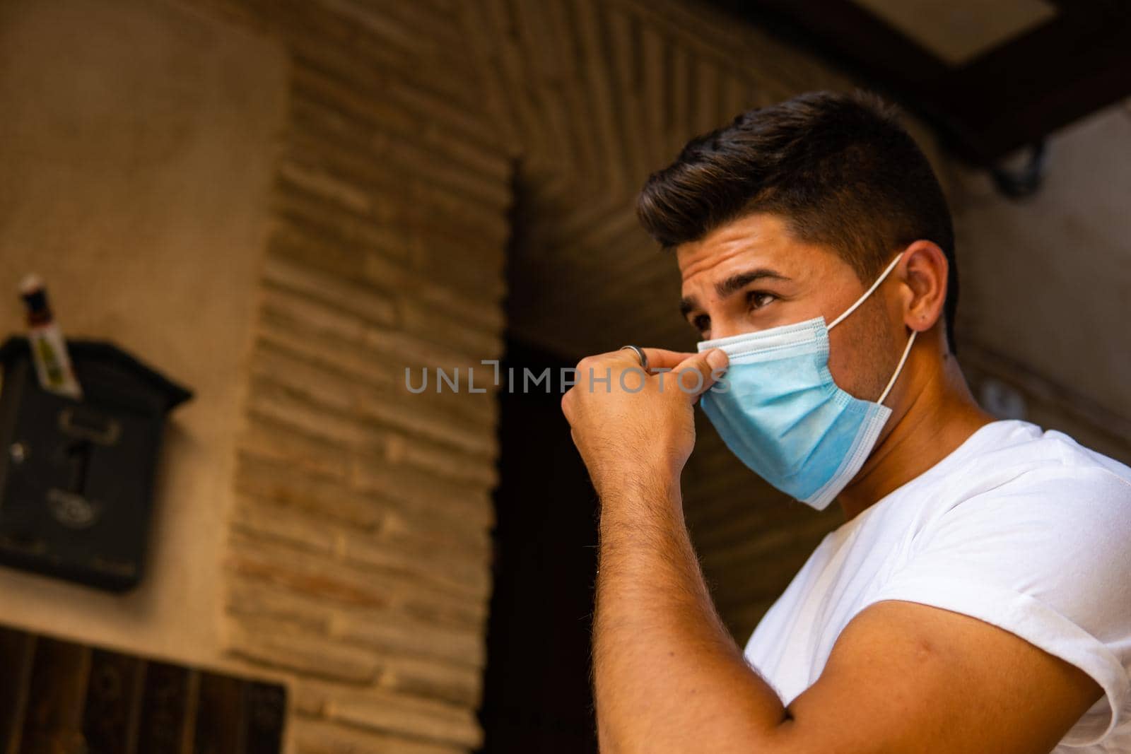 Brown-haired man with a mask White T-shirt with brown background