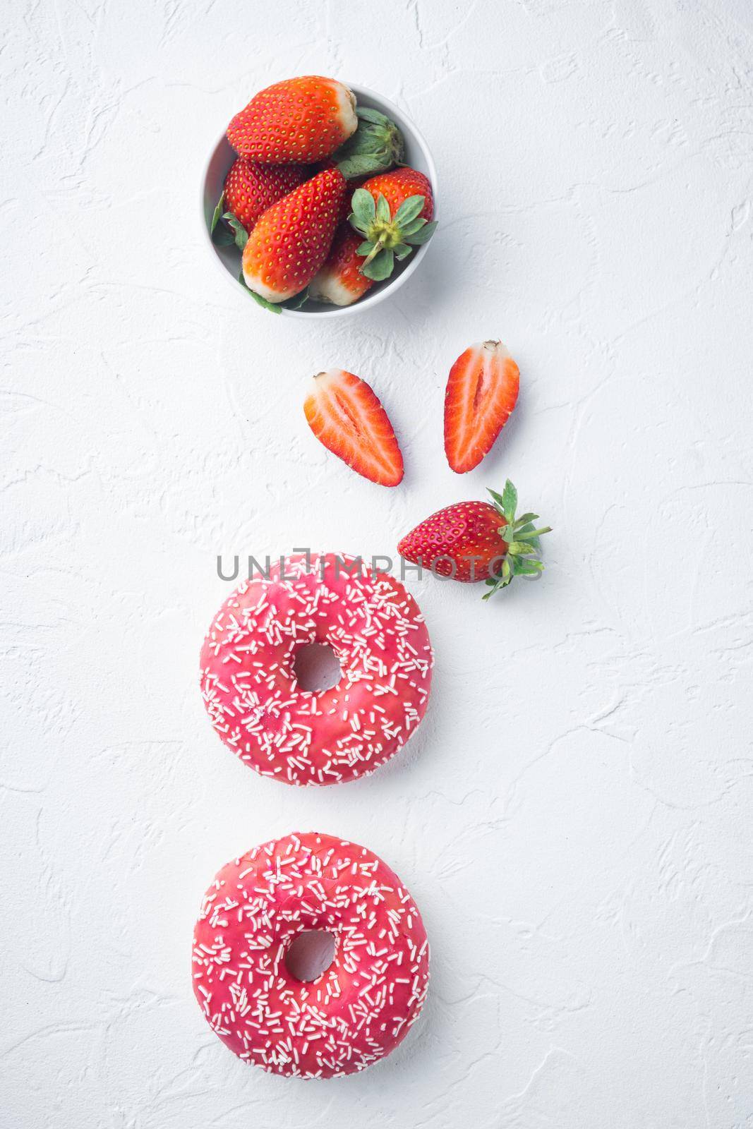 Strawberry Donuts with berrie, on white background, top view flat lay