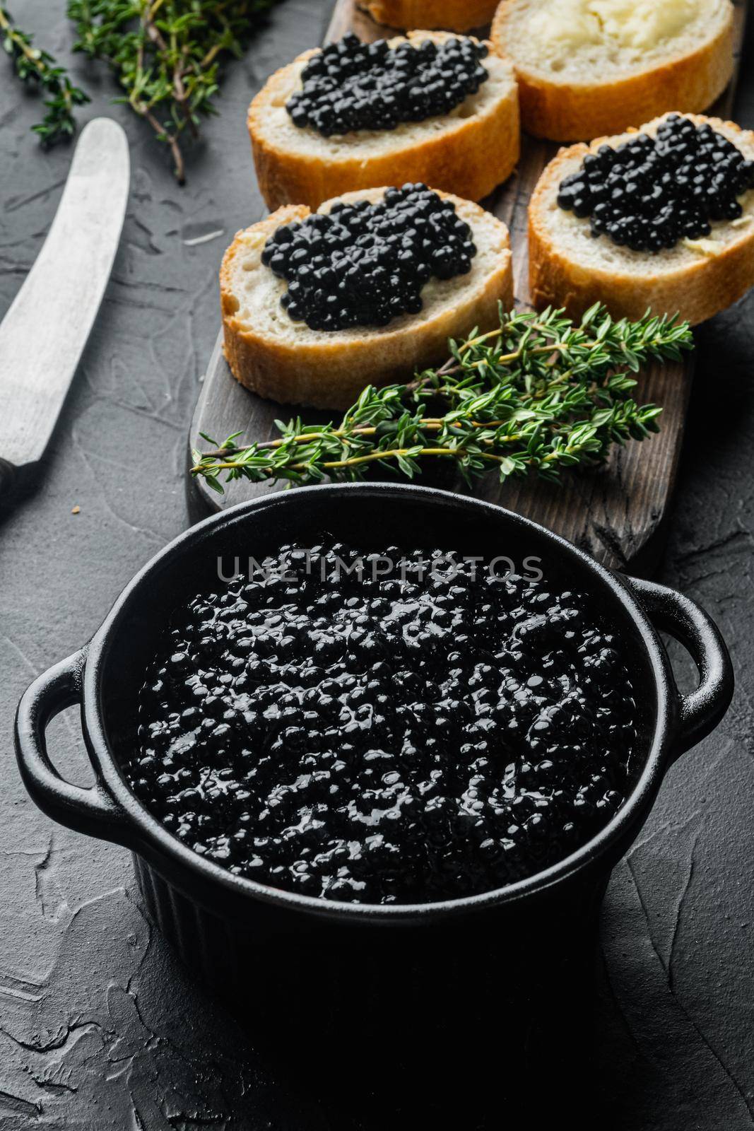 Sandwiche with black caviar, on black background