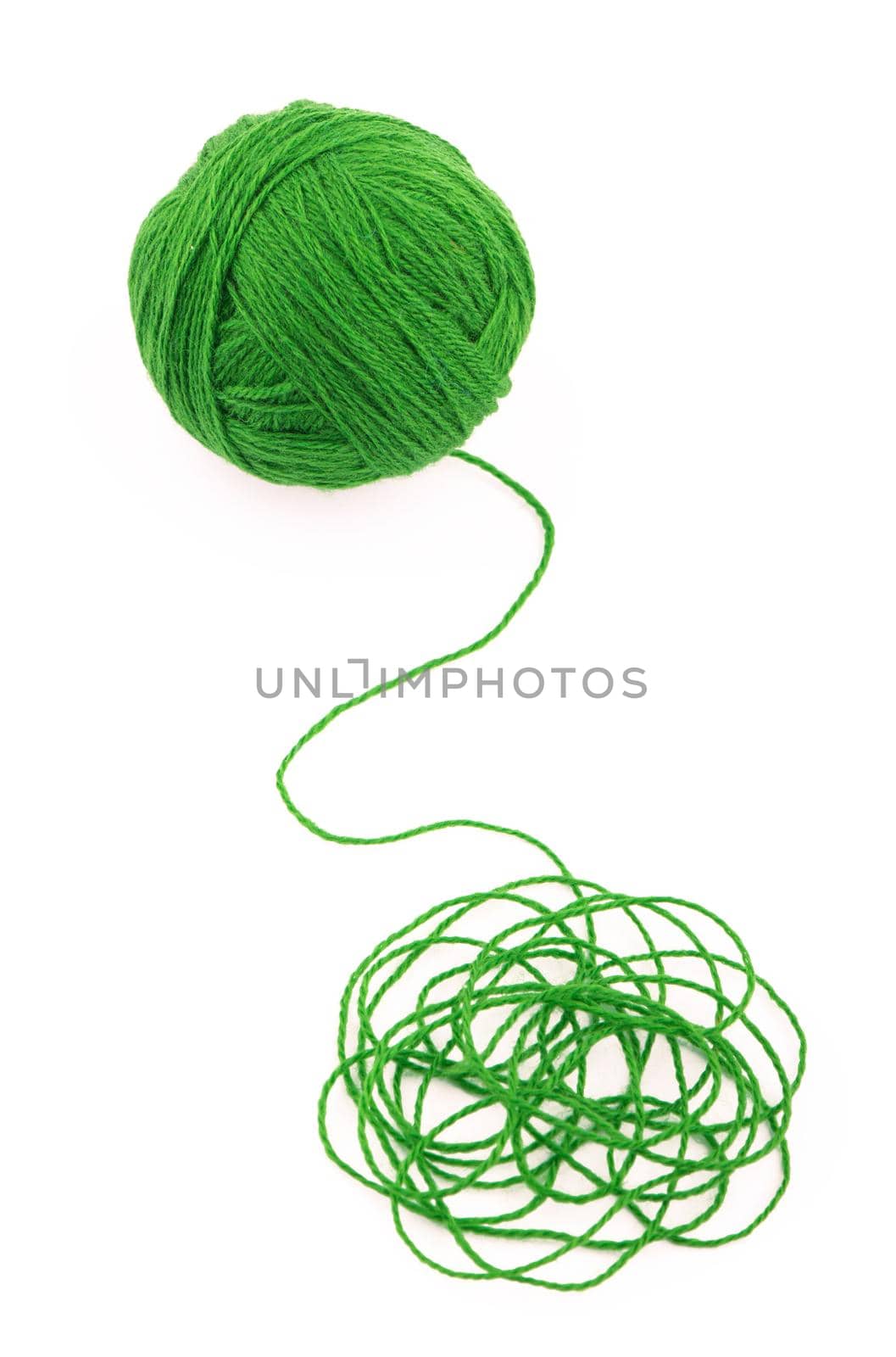 The idea is a tangled thread. Green ball of yarn on white background