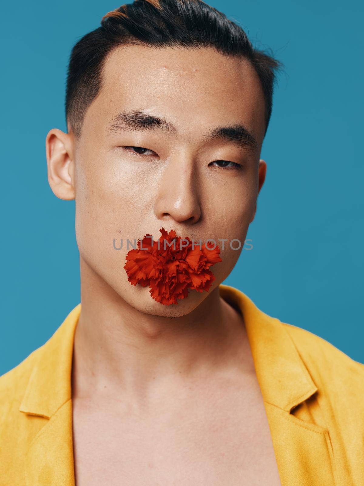 Romantic Korean man with a flower in his mouth on a blue background by SHOTPRIME