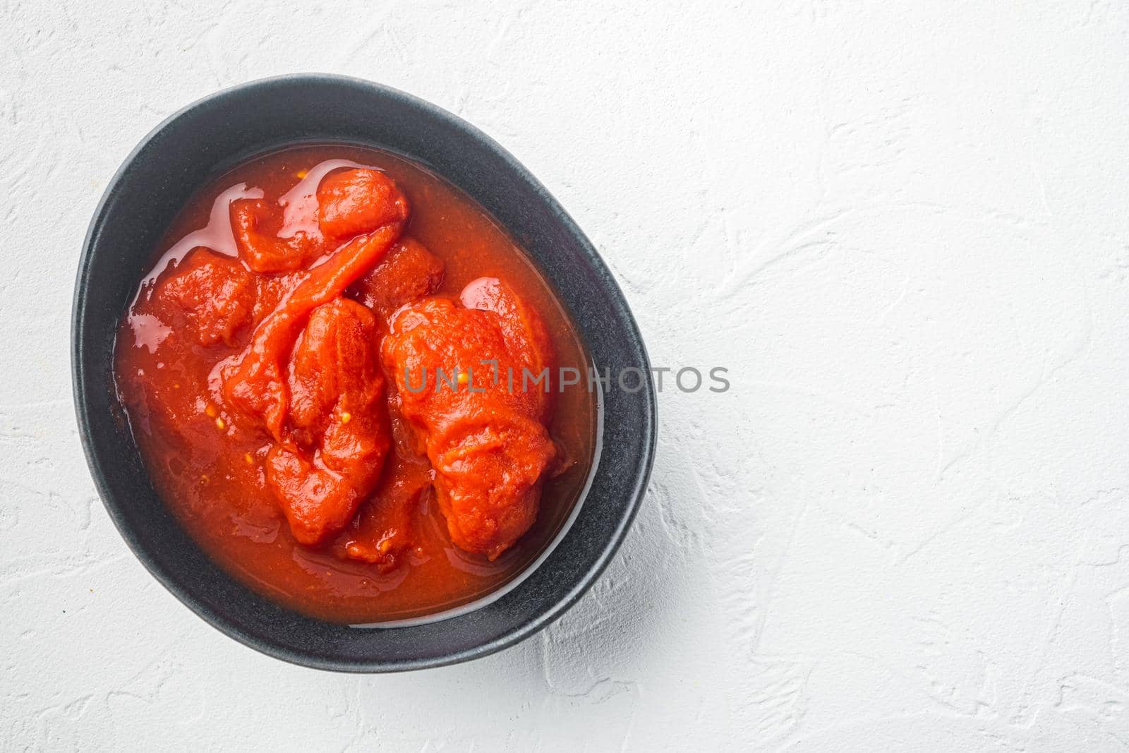 Whole canned tomatoe, on white background, top view flat lay with copy space for text