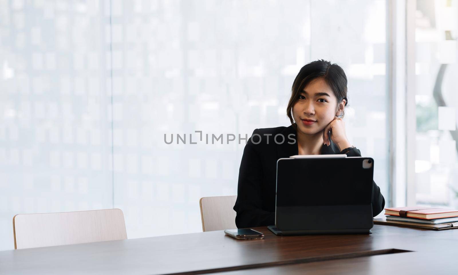 Portrait Of Attractive Asian Businesswoman Working On Laptop for marketing plan. by nateemee