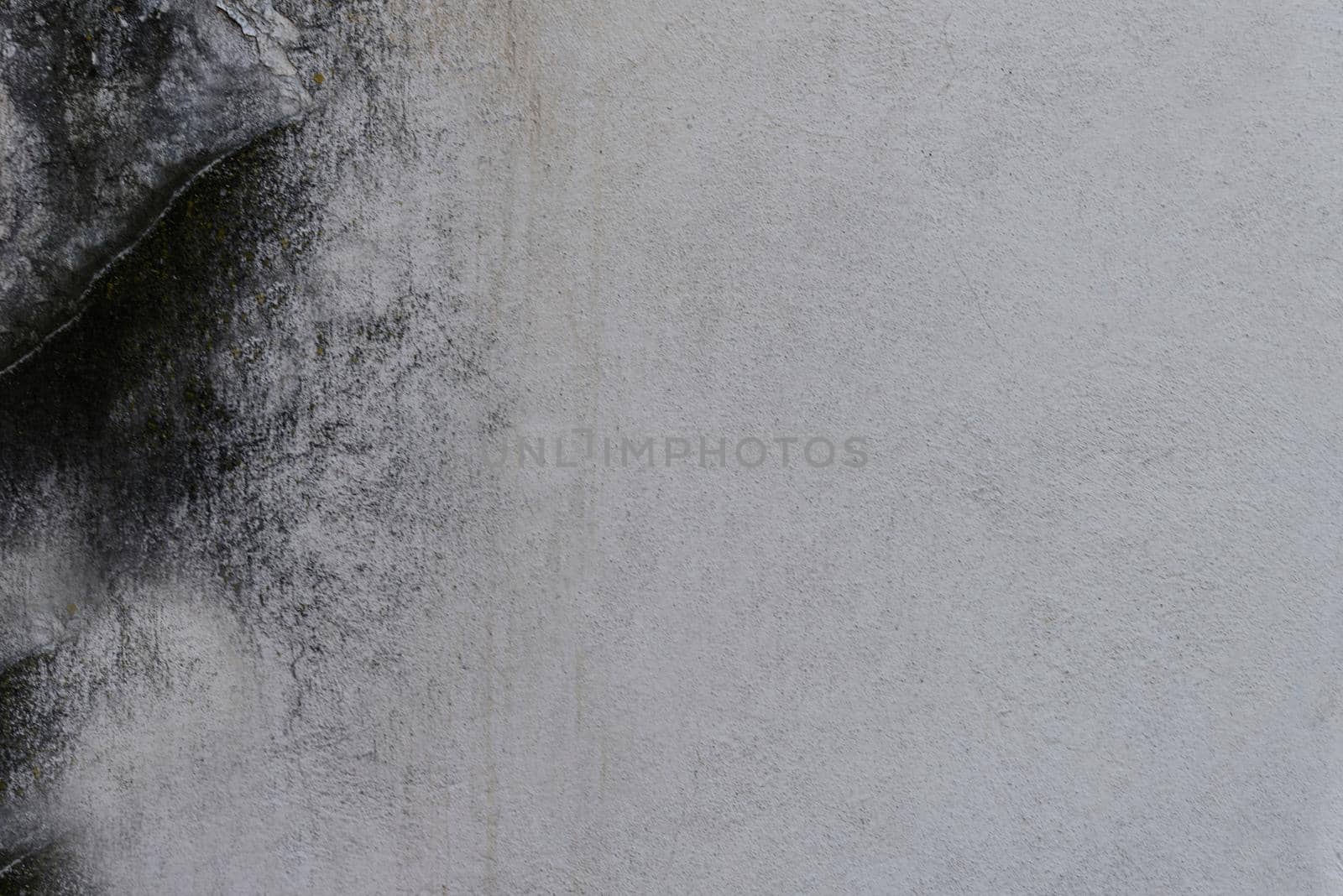 The texture of a gray concrete wall with scratches and stains on the surface.Texture or background