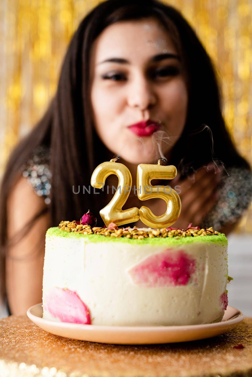 Birthday party. Attractive caucasian woman in black party dress ready to eat birthday cake celebrating her twenty fifth birthday