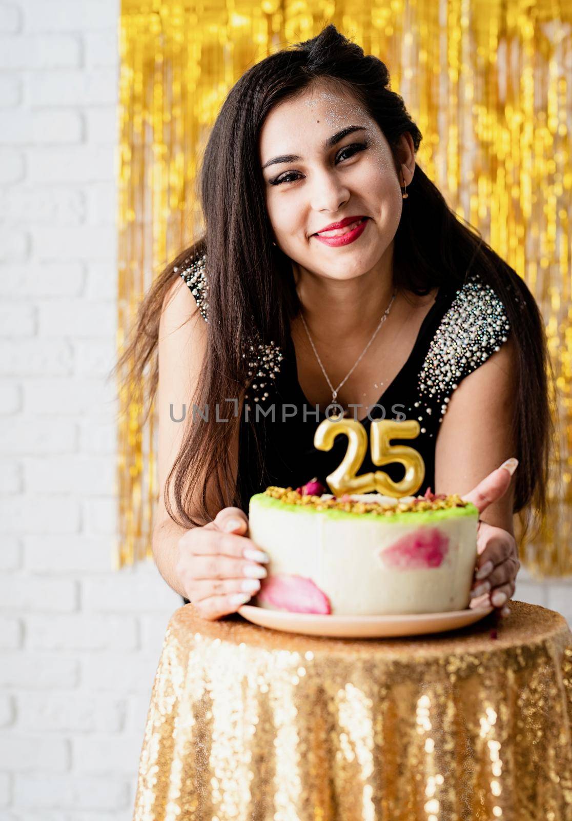 Birthday party. Attractive caucasian woman in black party dress ready to eat birthday cake celebrating her twenty fifth birthday