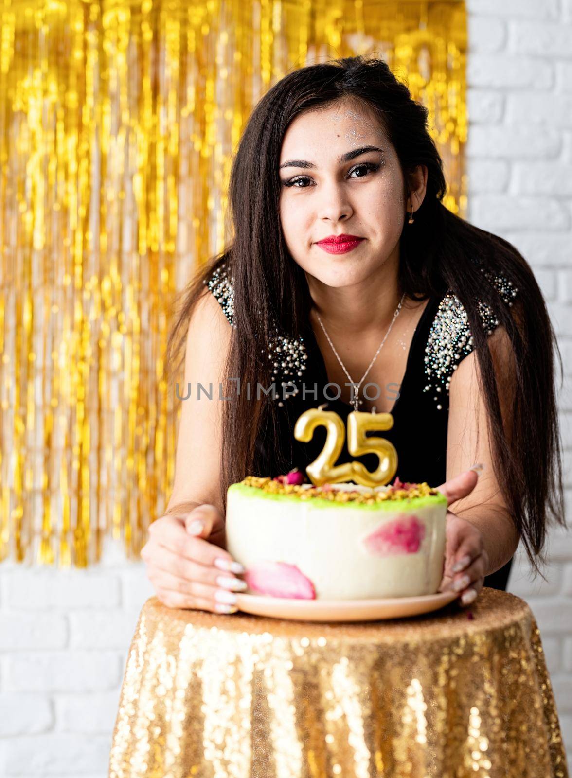 Birthday party. Attractive caucasian woman in black party dress ready to eat birthday cake celebrating her twenty fifth birthday