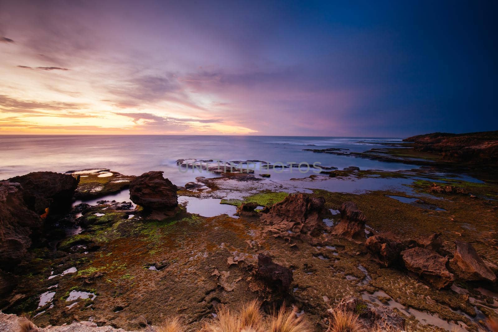The idyllic Pearses Beach and headland around Pirates Bay Cove on a hot summer's evening near Blairgowrie, Victoria, Australia