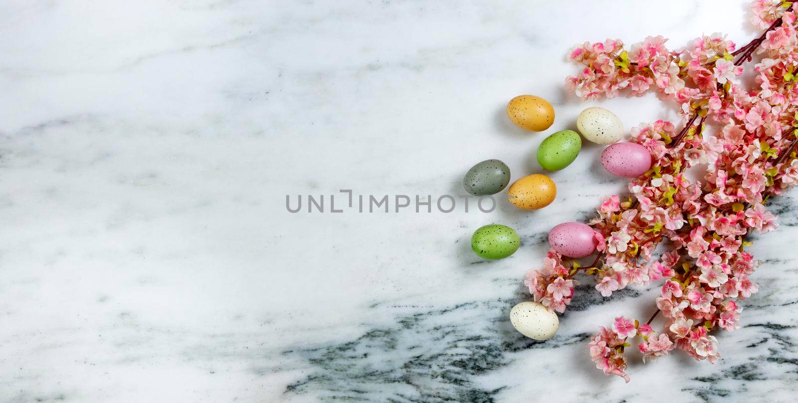 Easter concept with spring cherry blossoms and colorful eggs on stone background by tab1962