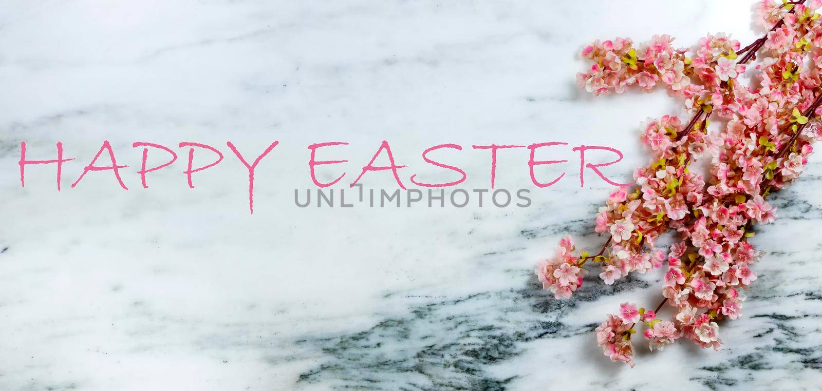 Happy Easter concept with springtime cherry blossoms on stone background plus added texted message
