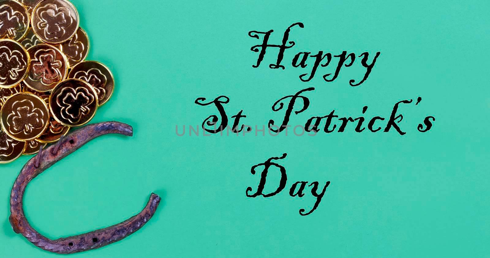 St Patricks day Irish good luck items with golden coins and horseshoe on a green paper background plus text by tab1962