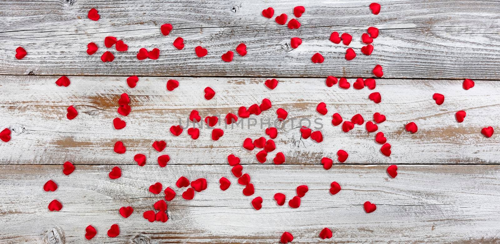Red lovely hearts on white rustic natural wood in flay lay composition for Valentines Day concept by tab1962