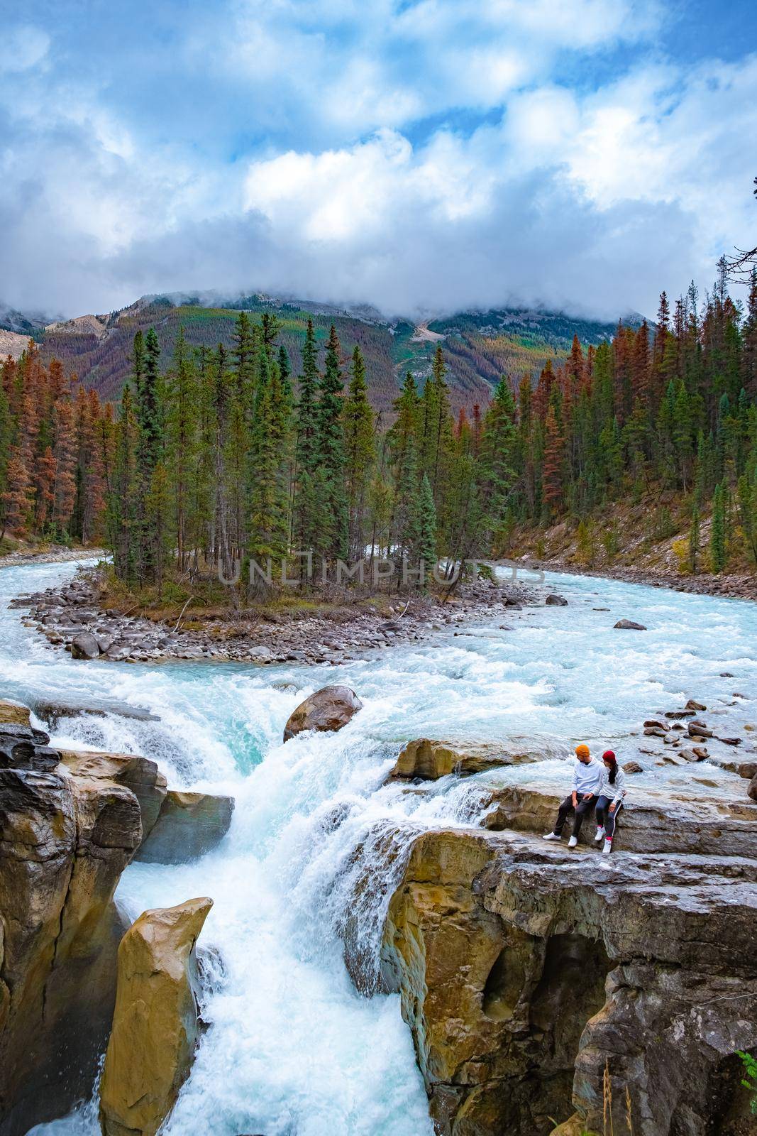 Beautiful view of Sunwapta Falls Jasper National Park, Canada, couple men and woman visit Sunwapta Falls Jasper by fokkebok