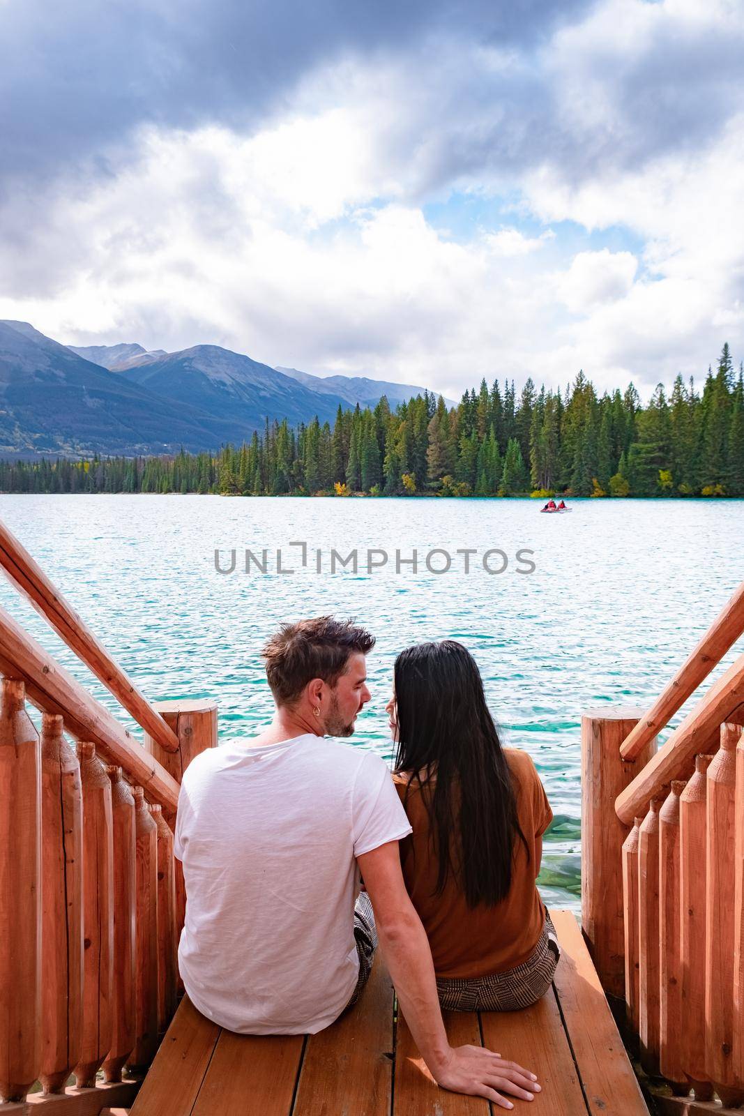 Beauvert lake at Jasper, Canada, Canadian lake popular for canoe. in the Canadian Rockies Jasper national park, couple men and woman mid age looking out over the lake