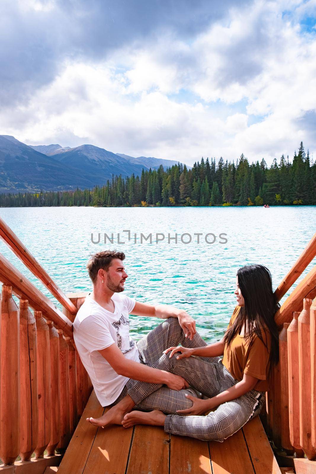 Beauvert lake at Jasper, Canada, Canadian lake popular for canoe. in the Canadian Rockies Jasper national park, couple men and woman mid age looking out over the lake