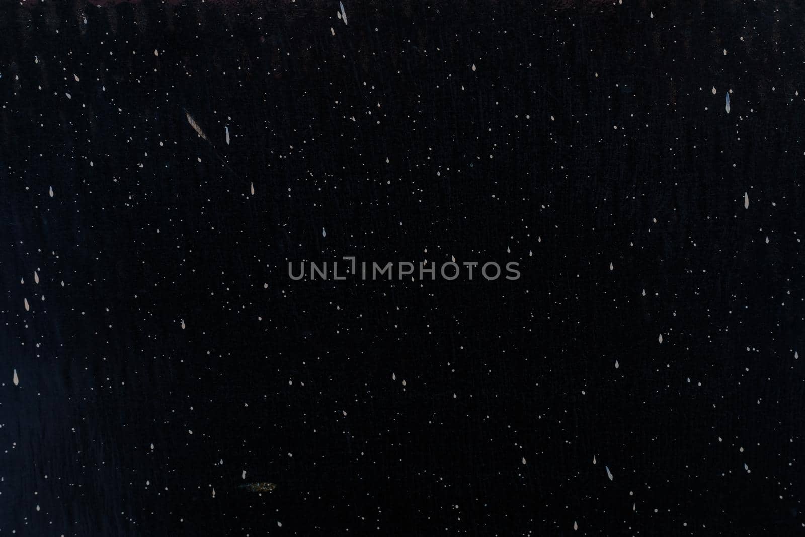 Background, texture of splashes of white drops on a black wall. Abstraction by Yurich32