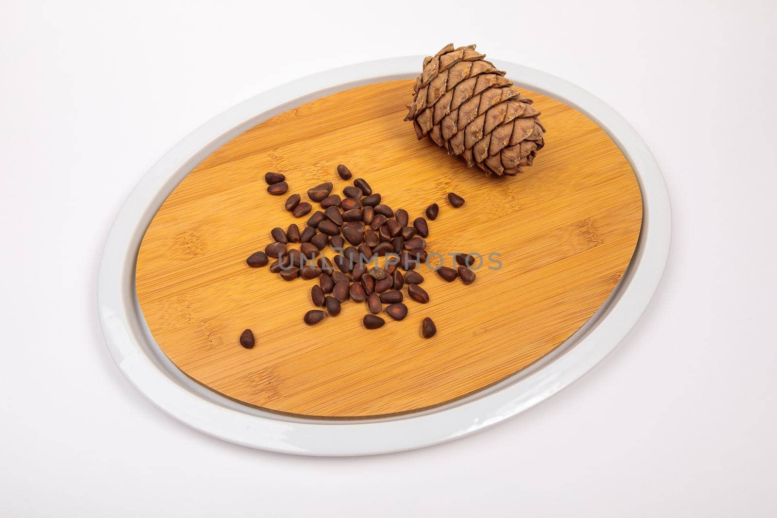 Siberian cones fruit - pine nuts on a kitchen cutting board by Yurich32
