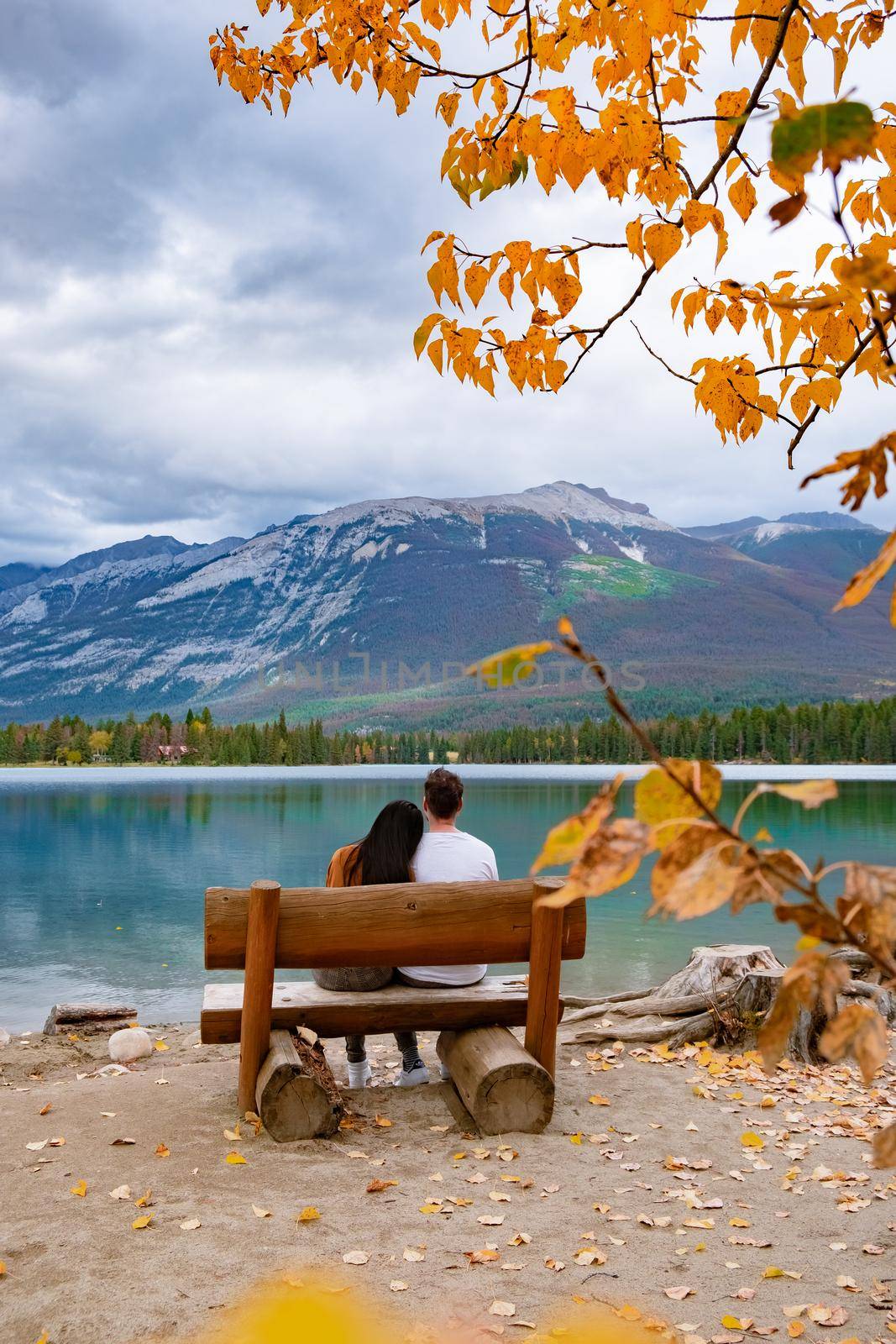 Beauvert lake at Jasper, Canada, Canadian lake popular for canoe. in the Canadian Rockies Jasper national park, couple men and woman mid age looking out over the lake