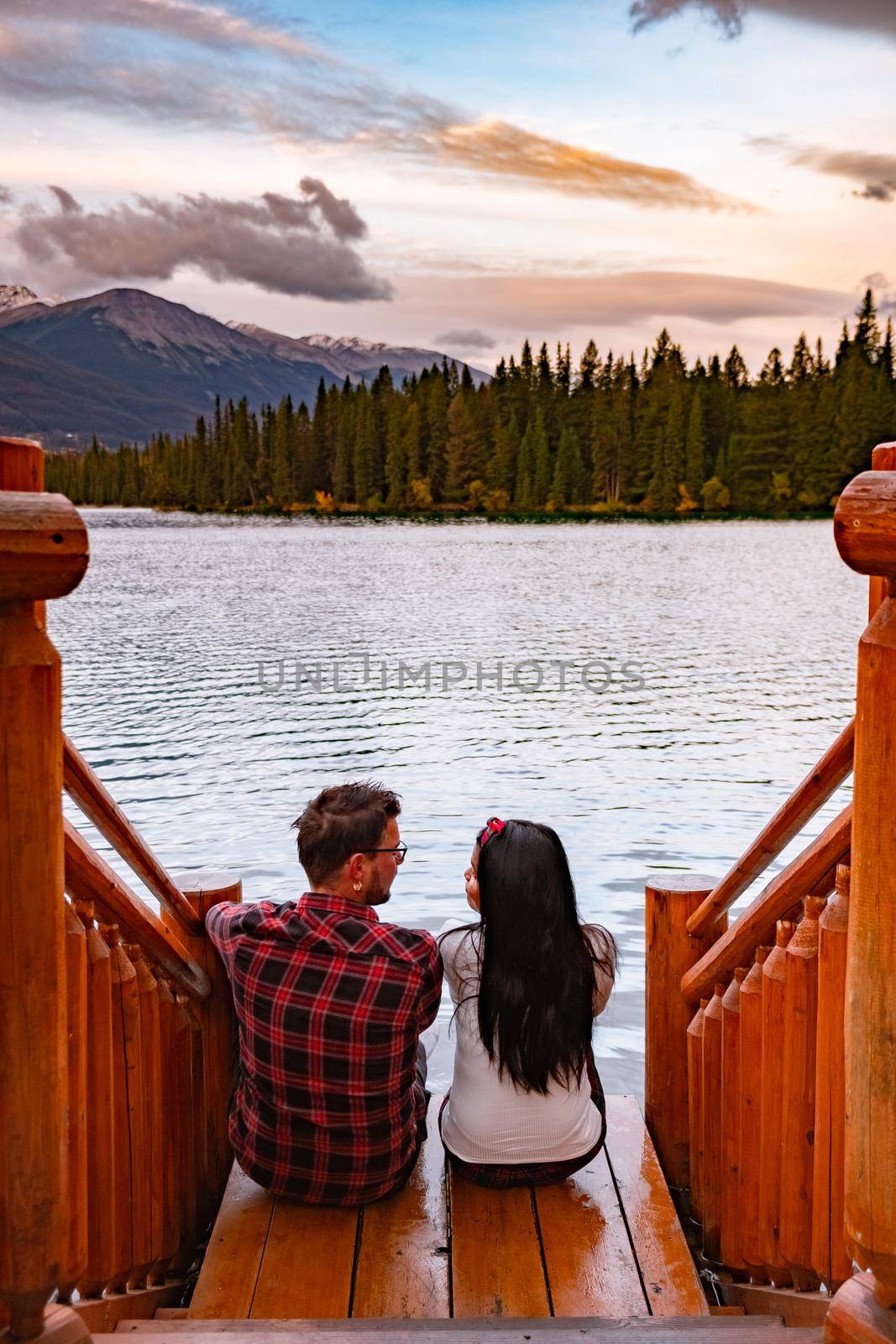 Beauvert lake at Jasper, Canada, Canadian lake popular for canoe. in the Canadian Rockies Jasper national park, couple men and woman mid age looking out over the lake