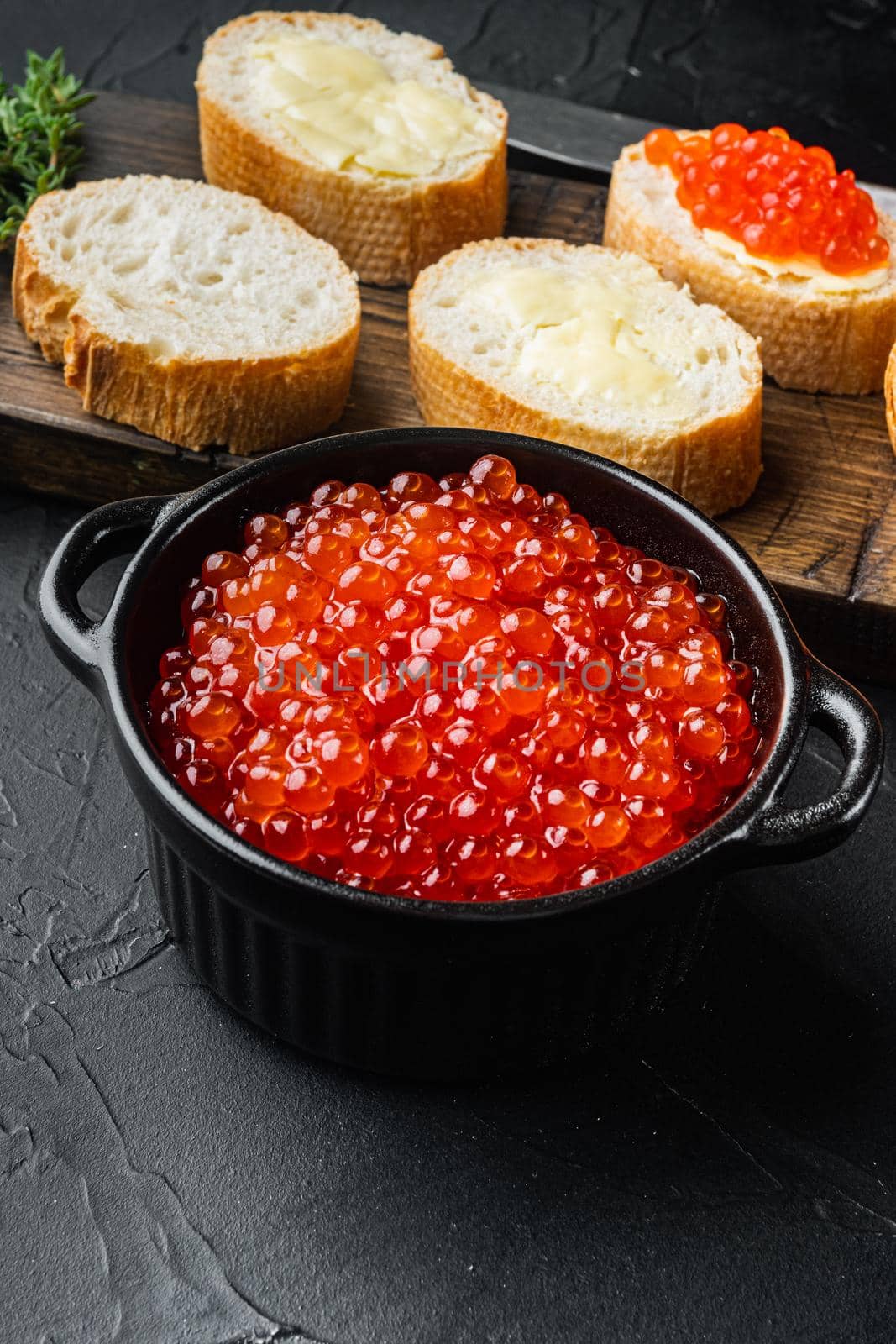Canape with Red Salmon Caviar, for New Year, on black background