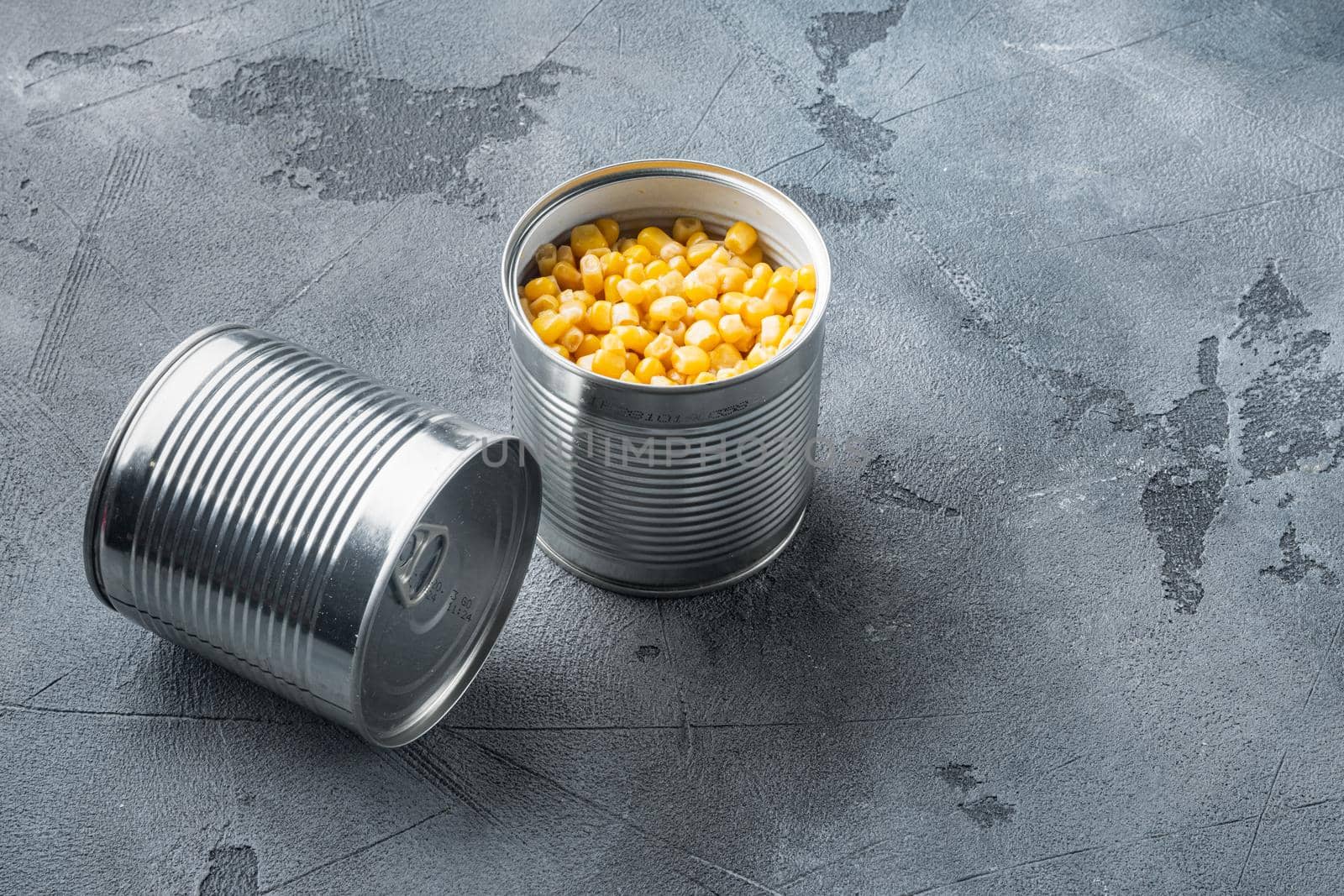 Canned corn in can, on gray background with copy space for text