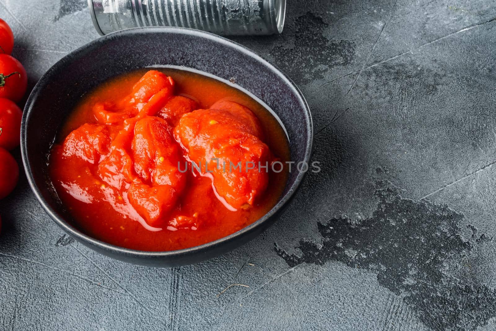 Peeled tomatoe, on gray background with copy space for text