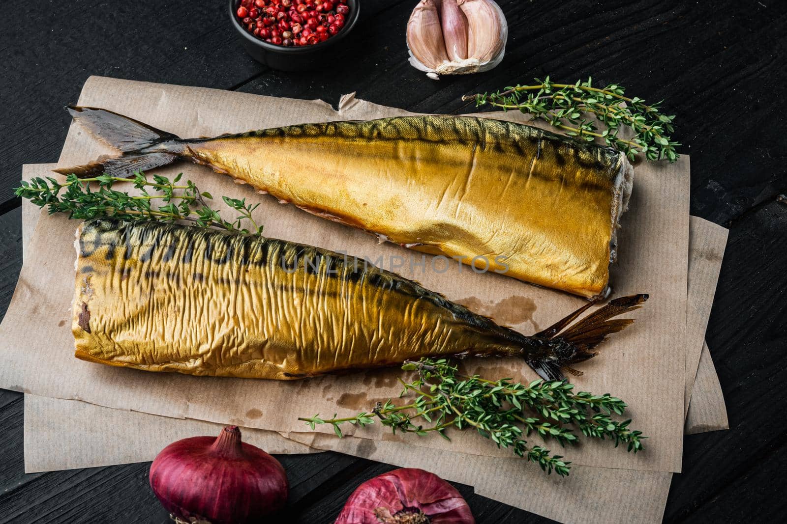 Smoked fish mackerel, on black wooden table background