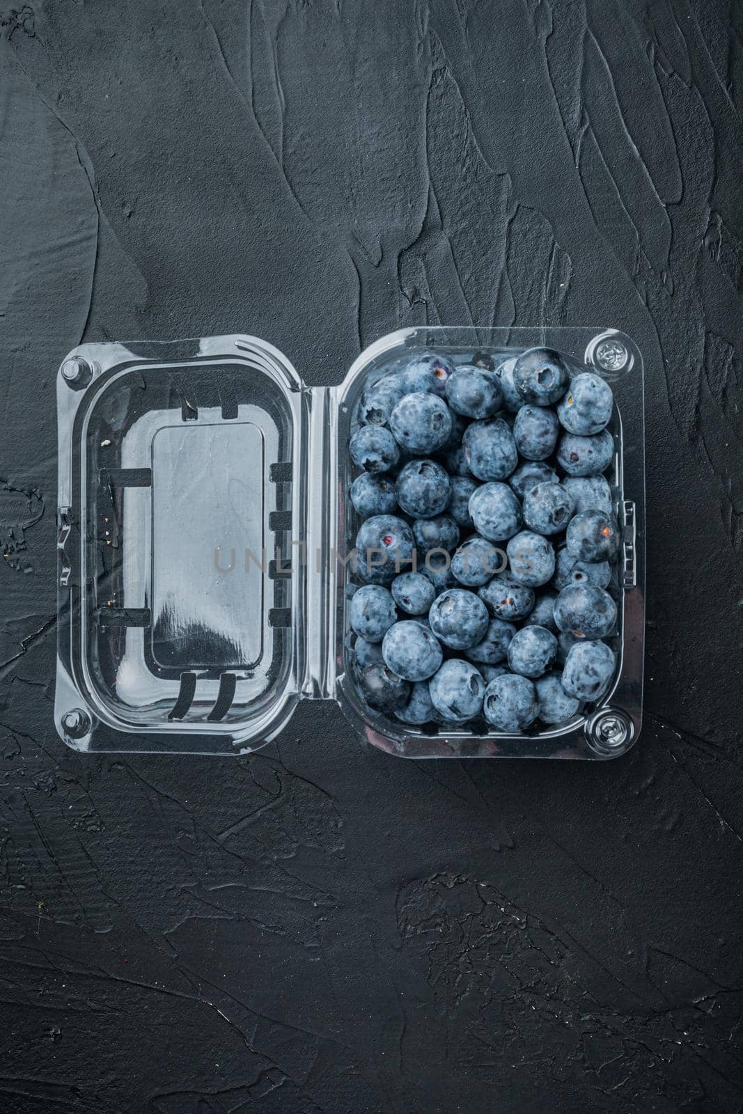 Quarts of blueberrie, on black background, top view flat lay