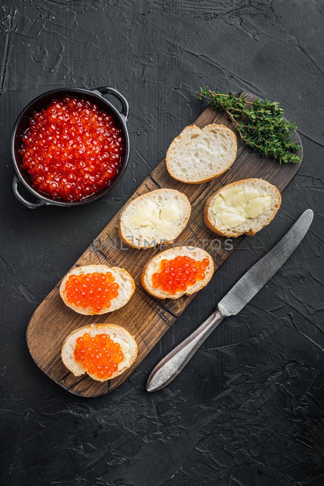 Canape with Red Salmon Caviar, for New Year, on black background, top view flat lay